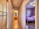 Hallway view to purple bedroom and wood vanity bathroom at 44182 W Juniper Ave, Maricopa, AZ 85138