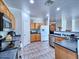Traditional kitchen featuring wood cabinets, modern appliances, and tile flooring at 44182 W Juniper Ave, Maricopa, AZ 85138
