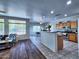 Open-concept kitchen with modern appliances and an island overlooking the dining area at 44182 W Juniper Ave, Maricopa, AZ 85138