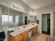 This bathroom boasts dual sinks, wood cabinets, and a separate walk-in tub and shower at 44182 W Juniper Ave, Maricopa, AZ 85138