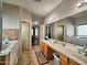 This bathroom boasts dual sinks, wood cabinets, and a separate walk-in tub and shower at 44182 W Juniper Ave, Maricopa, AZ 85138