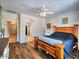 This bright main bedroom features wood floors, ceiling fan, and ensuite access at 44182 W Juniper Ave, Maricopa, AZ 85138