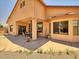 The patio features a table, chairs, and a ceiling fan for comfortable outdoor living at 44182 W Juniper Ave, Maricopa, AZ 85138