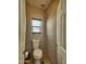 This powder room has a toilet and small window at 44182 W Juniper Ave, Maricopa, AZ 85138