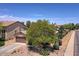 Charming home exterior with a well-maintained front yard and mature shade tree at 44182 W Juniper Ave, Maricopa, AZ 85138