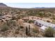Wide aerial shot showcasing the homes in a desert landscape with mountains in the distance at 49039 N 24Th Ave, New River, AZ 85087