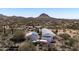 Aerial view showing the house with solar panels in a scenic desert setting at 49039 N 24Th Ave, New River, AZ 85087