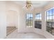 Bright dining nook with multiple windows showcasing mountain views and arched entryway at 49039 N 24Th Ave, New River, AZ 85087