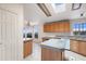 Bright kitchen with island, oak cabinets, and views of the surrounding landscape at 49039 N 24Th Ave, New River, AZ 85087