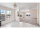 Open-concept living area with tile and carpet flooring, enhanced by large windows providing natural light at 49039 N 24Th Ave, New River, AZ 85087