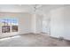 A bright living room featuring plush carpet and many windows at 49039 N 24Th Ave, New River, AZ 85087