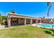 Backyard with a pool, hot tub, seating, and lush green landscaping for ultimate relaxation at 4940 S Rosemary Dr, Chandler, AZ 85248