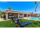 Backyard with a pool and lounge chairs, along with a covered seating area for entertaining at 4940 S Rosemary Dr, Chandler, AZ 85248