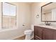 Bathroom with natural light, vanity, and a granite countertop and matching fixtures at 4940 S Rosemary Dr, Chandler, AZ 85248