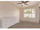 Bedroom with a dresser and window complete with shutters, as well as a ceiling fan at 4940 S Rosemary Dr, Chandler, AZ 85248