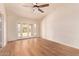 Bedroom featuring beautiful hardwood floors, a ceiling fan and double french doors at 4940 S Rosemary Dr, Chandler, AZ 85248