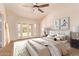 Staged bedroom showcasing French doors, ceiling fan, and neutral decor for a relaxing ambiance at 4940 S Rosemary Dr, Chandler, AZ 85248