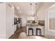 Kitchen with stainless steel appliances, granite countertops, white cabinets, and an eat-in bar at 4940 S Rosemary Dr, Chandler, AZ 85248