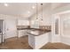 Bright kitchen with white cabinets, granite counters, stainless steel appliances, tile backsplash and modern lighting at 4940 S Rosemary Dr, Chandler, AZ 85248