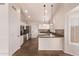 Bright kitchen with white cabinets, granite counters, stainless steel appliances, tile backsplash and modern lighting at 4940 S Rosemary Dr, Chandler, AZ 85248