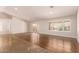 Empty living room featuring hard floors, white walls, French doors and bright natural lighting through shuttered windows at 4940 S Rosemary Dr, Chandler, AZ 85248