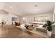 Modern living room design with neutral color palette, stylish furniture, large windows, and tile flooring at 4940 S Rosemary Dr, Chandler, AZ 85248
