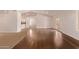 Empty living room featuring hard floors, white walls, French doors and bright natural lighting through shuttered windows at 4940 S Rosemary Dr, Chandler, AZ 85248