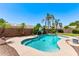Inviting backyard pool with a pristine patio, lush landscaping, and sparkling blue water at 4940 S Rosemary Dr, Chandler, AZ 85248