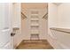 Open walk-in closet with built-in shelving and rods for organized storage at 4940 S Rosemary Dr, Chandler, AZ 85248