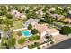 An aerial shot captures a home featuring a pool and well-maintained landscaping in a quiet neighborhood setting at 541 E Spur Ave, Gilbert, AZ 85296