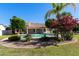 Serene backyard featuring a sparkling pool, mature trees, and vibrant landscaping at 541 E Spur Ave, Gilbert, AZ 85296