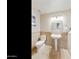 A beige tiled bathroom with a toilet, pedestal sink, decorative mirror, and stylish sconces at 541 E Spur Ave, Gilbert, AZ 85296