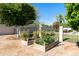 A charming garden showcases raised beds and an archway, perfect for cultivating vegetables and flowers at 541 E Spur Ave, Gilbert, AZ 85296