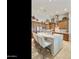A kitchen features a large island with seating and natural wood cabinetry, illuminated by recessed lighting at 541 E Spur Ave, Gilbert, AZ 85296