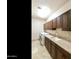 Laundry room featuring modern washer and dryer, granite countertops, tiled floor, and upper cabinets at 541 E Spur Ave, Gilbert, AZ 85296