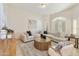 Bright living room features modern furniture, a round wood table, large windows and neutral colors at 541 E Spur Ave, Gilbert, AZ 85296