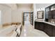 Spacious main bathroom with a soaking tub, dual vanity, and access to a walk-in closet at 541 E Spur Ave, Gilbert, AZ 85296