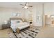 Luxurious main bedroom boasts high ceilings, a ceiling fan, a large bed, and an open doorway to bathroom at 541 E Spur Ave, Gilbert, AZ 85296