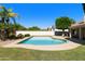 Sparkling pool surrounded by lush landscaping and a privacy fence, creating a private oasis in the backyard at 541 E Spur Ave, Gilbert, AZ 85296