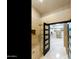 A modern shower features neutral tile, glass doors, and dark wood doors leading to walk-in closet at 541 E Spur Ave, Gilbert, AZ 85296