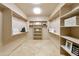 Spacious walk-in closet with custom shelving and ample storage space for clothes and accessories at 541 E Spur Ave, Gilbert, AZ 85296