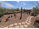 Beautiful backyard with desert landscaping and a stone path at 5637 E Lonesome Trl, Cave Creek, AZ 85331