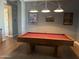 Spacious game room with an oak pool table, hardwood floors, and gray walls at 5637 E Lonesome Trl, Cave Creek, AZ 85331
