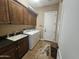 Well-equipped laundry room with washer, dryer, sink, and ample cabinet storage at 5637 E Lonesome Trl, Cave Creek, AZ 85331