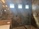 Walk-in shower with glass surround and a handheld shower head with tile surround and flooring at 5637 E Lonesome Trl, Cave Creek, AZ 85331