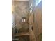 Walk-in shower featuring tile surround, bench seating, and recessed shelving for storage at 5637 E Lonesome Trl, Cave Creek, AZ 85331