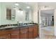 Bathroom with double vanity, granite countertop, and a view into the bedroom at 5818 N 3Rd Ave, Phoenix, AZ 85013