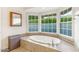 Luxurious bathtub situated beneath large windows that provide an abundance of natural light at 5818 N 3Rd Ave, Phoenix, AZ 85013