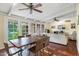 Open-concept dining area with hardwood floors, bright lighting, and views through glass doors to the backyard at 5818 N 3Rd Ave, Phoenix, AZ 85013