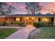 Charming brick home featuring a welcoming brick pathway, lovely landscaping, and a covered front porch at 5818 N 3Rd Ave, Phoenix, AZ 85013